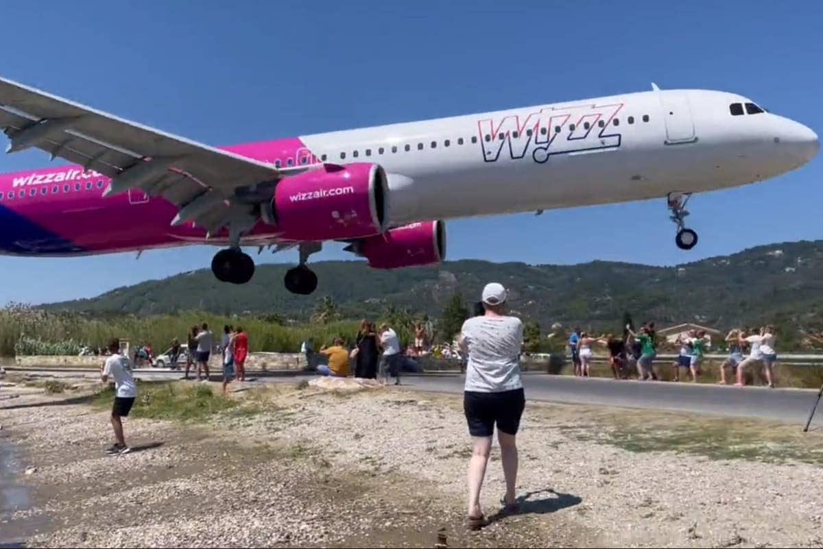 Moment plane makes jaw-dropping landing just metres above tourists heads at Greek airport